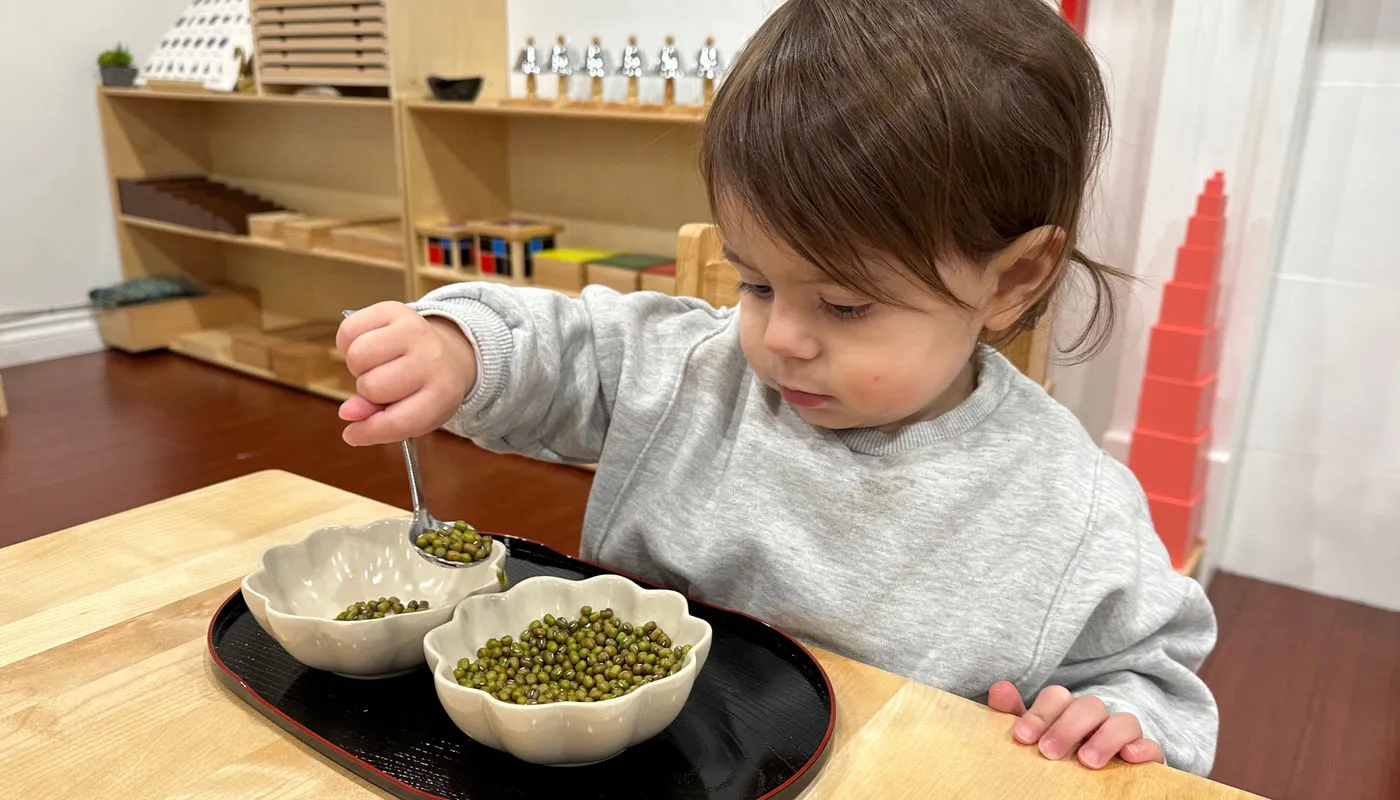 A child concentrating in a Montessori setting.