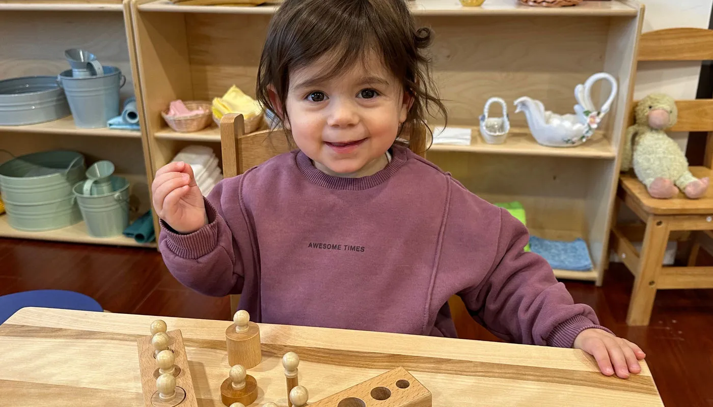 Children working with wooden Montessori materials.